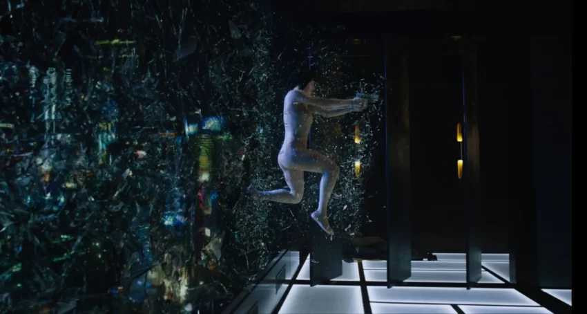 Photo du film Ghost in the Shell réalisé par Rupert Sanders avec Scarlett Johansson sautant à travers une vitre