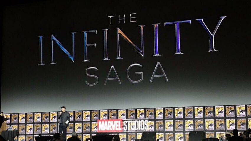 Photo du panel Marvel Studios à la Comic-Con 2019 avec Kevin Feige présentant le logo de The Infinity Saga